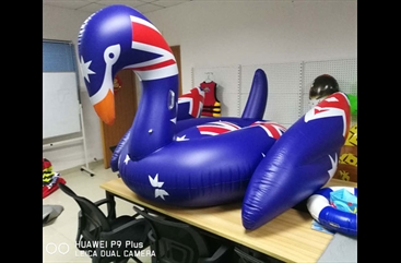 Blue inflatable swan floating row