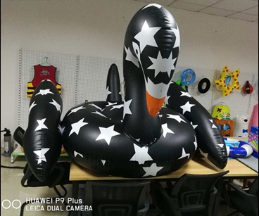 Black inflatable swan floating row